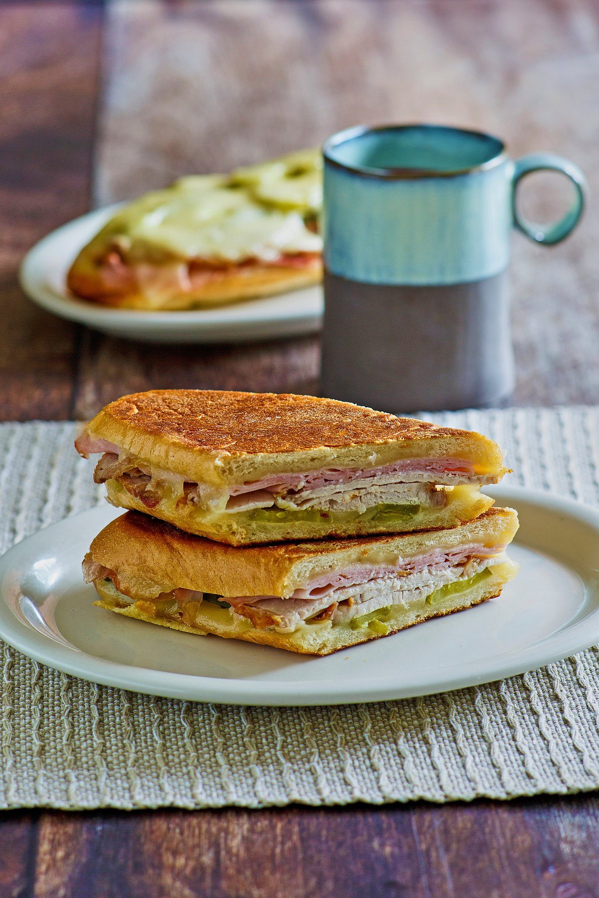 pressed Cuban sandwich with ham, pork, pickle, mustard and swiss cheese