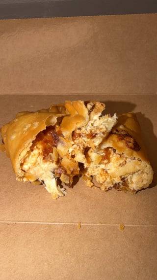 Golden brown pastry with nuts and caramel pieces on brown parchment paper